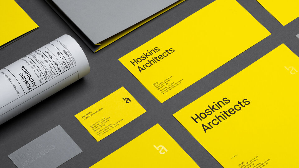 Various pieces of stationery in yellow and grey.